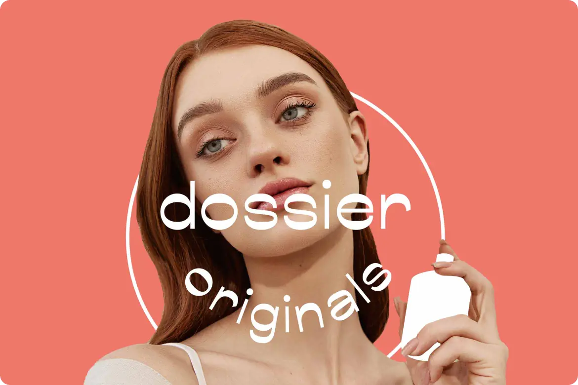 Woman holding a Dossier perfume bottle against a coral background with “Dossier Originals” graphic text.