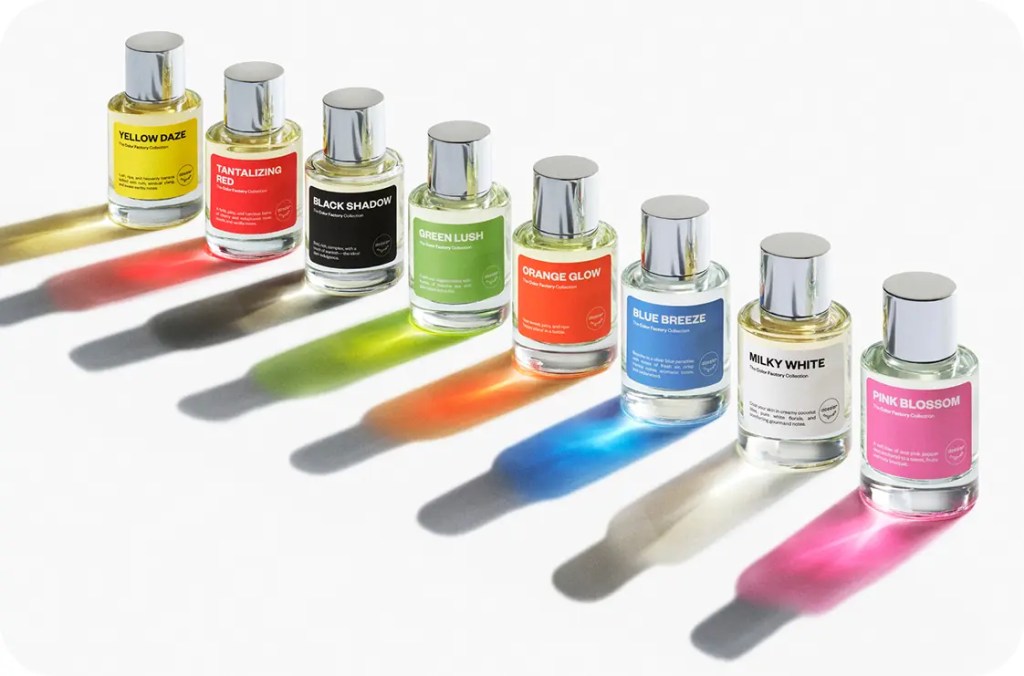Color Factory perfume bottles with colorful labels casting vibrant rainbow shadows on a white background.