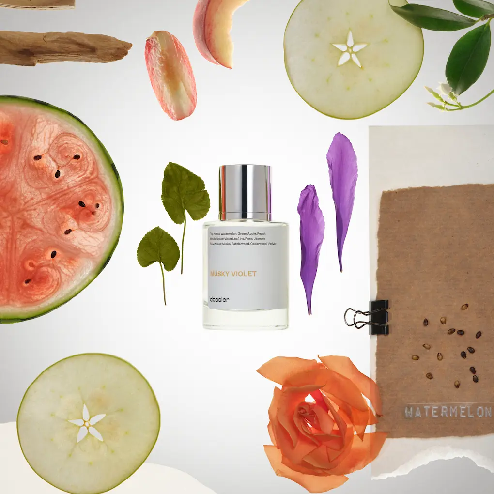 Dossier Musky Violet perfume surrounded by watermelon, apple slices, violet petals, leaves, peach, rose, and pieces of wood.