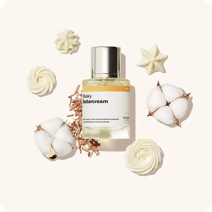 Dossier Musky Buttercream perfume displayed with cotton flowers, sandalwood shavings, and buttercream swirls.